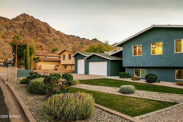 view of front of home with a mountain view and a garage