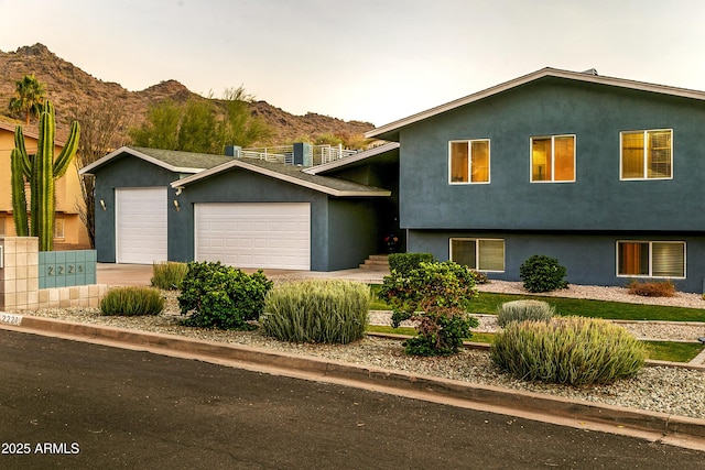 view of front of home featuring a garage and a mountain view