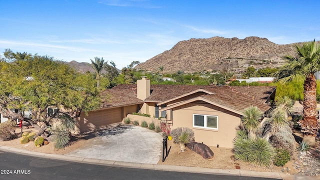 view of front of property with a mountain view and a garage