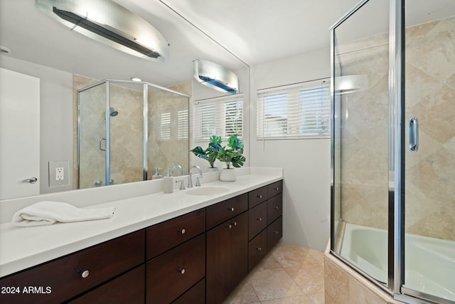 bathroom featuring a shower with door, vanity, and tile patterned flooring