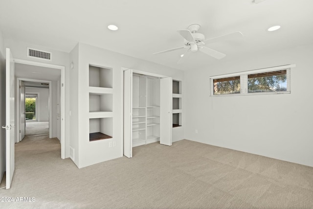 unfurnished bedroom with light carpet, a closet, and ceiling fan