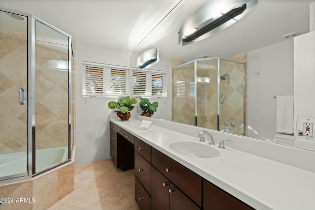 bathroom featuring tile patterned floors, vanity, and enclosed tub / shower combo