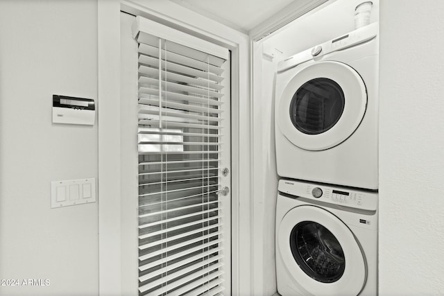 laundry room with stacked washer / drying machine