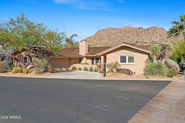 view of front facade featuring a mountain view and a garage