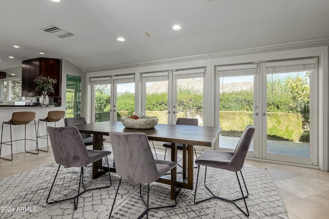 sunroom / solarium featuring vaulted ceiling, a wealth of natural light, and french doors