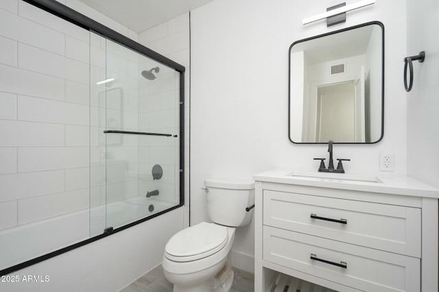 bathroom featuring baseboards, visible vents, bath / shower combo with glass door, toilet, and vanity