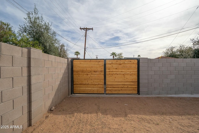 view of gate with fence