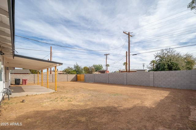 view of yard with a patio area, a fenced backyard, and central AC unit