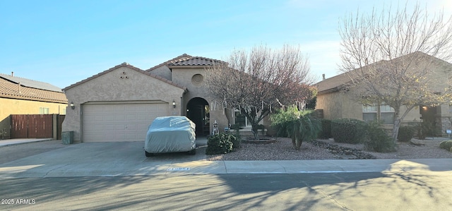 mediterranean / spanish-style house featuring a garage, driveway, a tile roof, and stucco siding