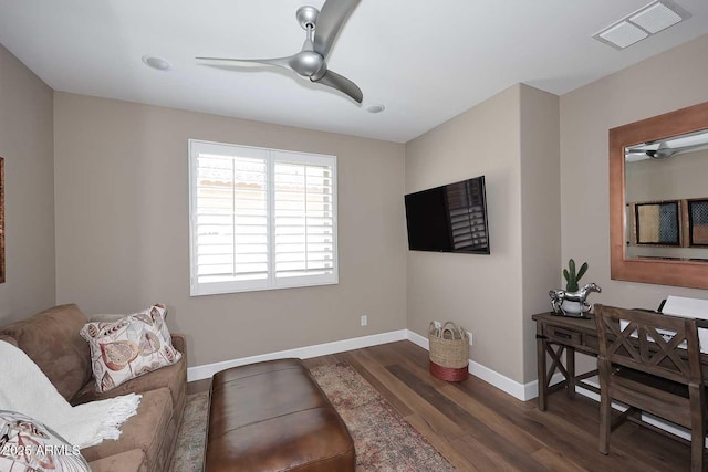 living area featuring visible vents, baseboards, wood finished floors, and a ceiling fan