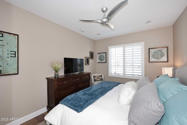 bedroom with dark wood-style floors, baseboards, and ceiling fan