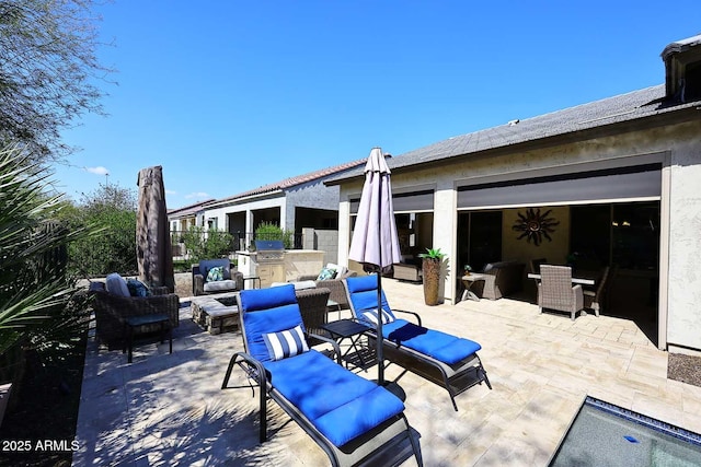 view of patio featuring outdoor lounge area, outdoor dry bar, and an outdoor kitchen