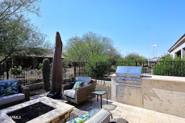 view of patio featuring area for grilling, a grill, an outdoor living space with a fire pit, and fence