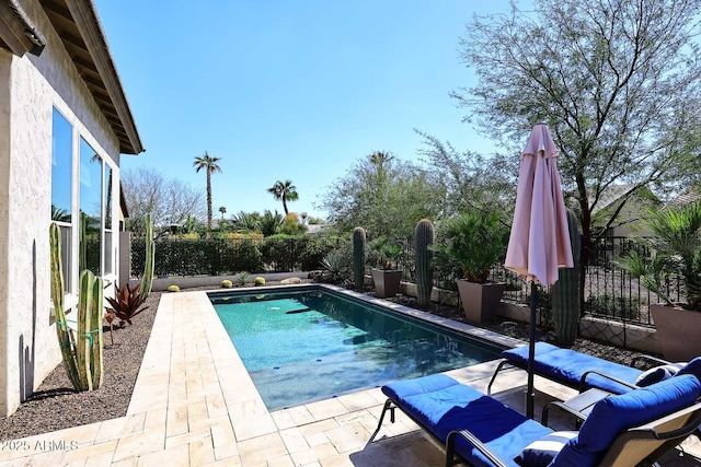 view of swimming pool featuring a patio area, a fenced in pool, and a fenced backyard