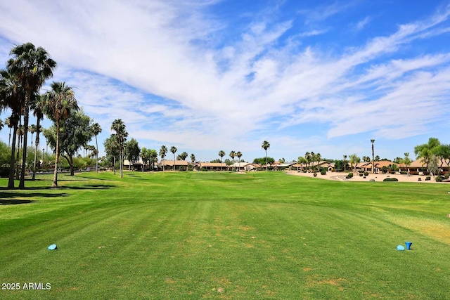 view of community with view of golf course and a lawn