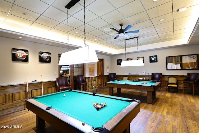 playroom with a wainscoted wall, pool table, a tray ceiling, and wood finished floors