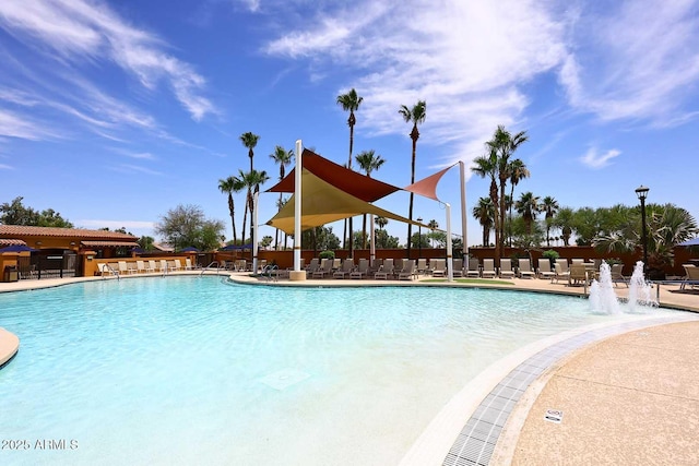 community pool featuring fence and a patio area