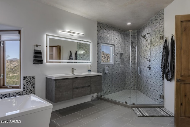 bathroom with vanity, a shower with shower door, and tile patterned floors