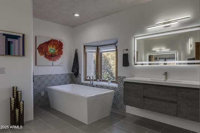 bathroom featuring tile patterned flooring, vanity, and tile walls