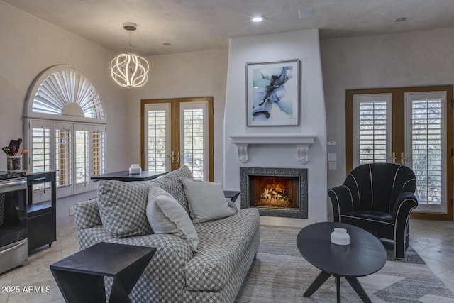 living room featuring an inviting chandelier and french doors