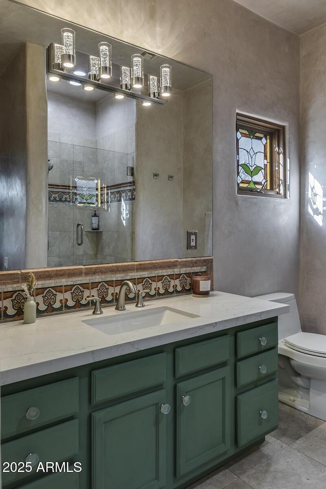 bathroom featuring walk in shower, vanity, and toilet