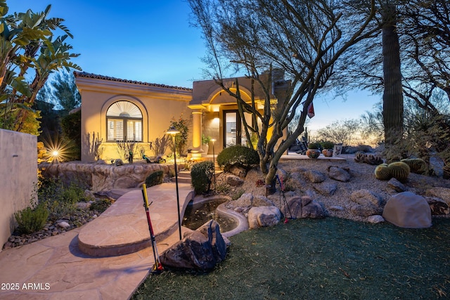 mediterranean / spanish-style home featuring a lawn