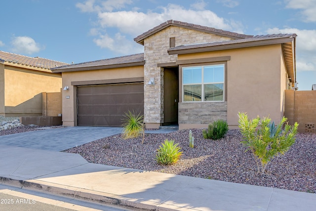 23461 N 76th Pl, Scottsdale, AZ 85255 - view of front of home with an attached garage, stone siding, stucco siding, and driveway