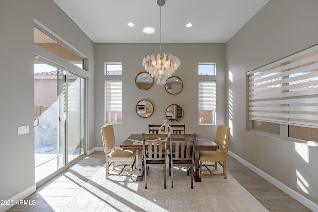 dining area with a healthy amount of sunlight, an inviting chandelier, and baseboards