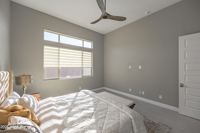 carpeted bedroom featuring lofted ceiling, baseboards, and a ceiling fan