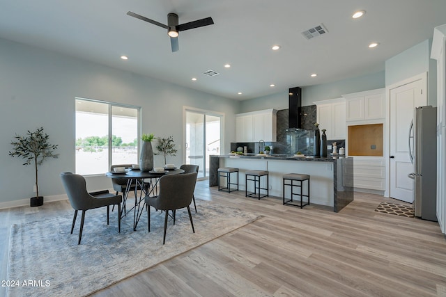 dining room featuring ceiling fan and light hardwood / wood-style flooring