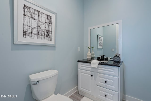 bathroom featuring vanity, toilet, and wood-type flooring