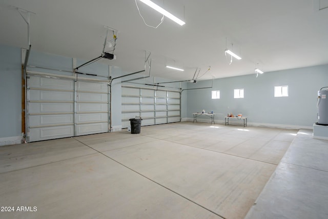 garage with electric water heater and a garage door opener