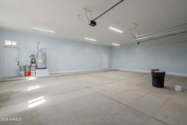 garage featuring a garage door opener and water heater