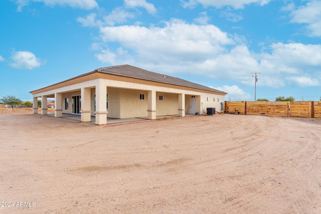 rear view of house with cooling unit and a patio