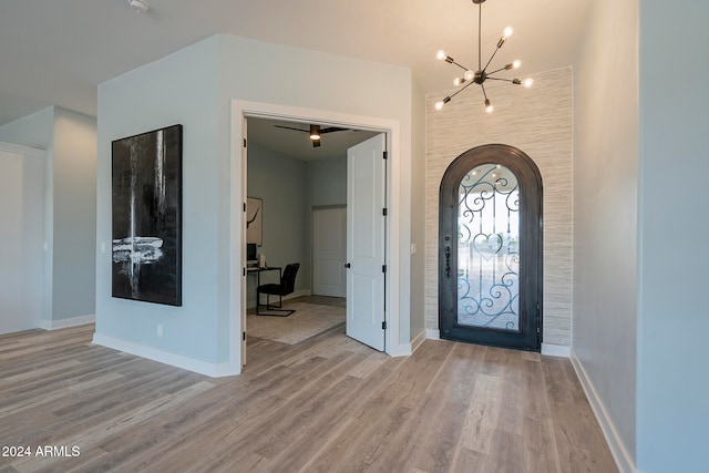 entrance foyer with a notable chandelier and light hardwood / wood-style flooring