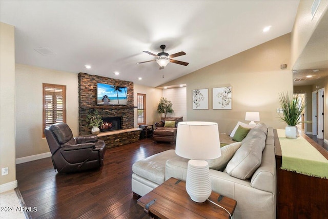 living room featuring ceiling fan, a fireplace, dark hardwood / wood-style floors, and vaulted ceiling