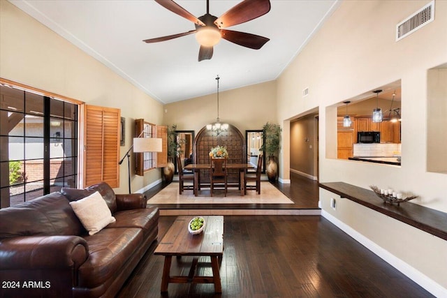 living room featuring high vaulted ceiling, dark hardwood / wood-style flooring, and ceiling fan with notable chandelier