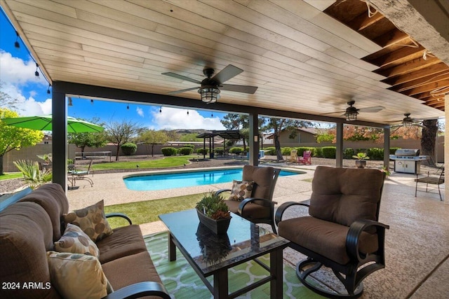 view of pool with a patio area, a pergola, a grill, ceiling fan, and an outdoor living space