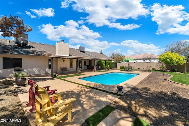 view of swimming pool with a patio and central air condition unit