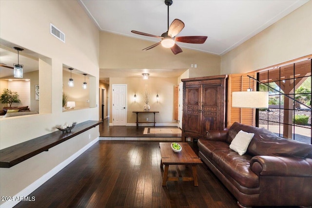 living room with ceiling fan, dark hardwood / wood-style floors, and vaulted ceiling