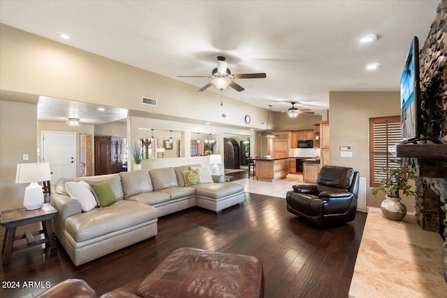 living room featuring hardwood / wood-style flooring and lofted ceiling