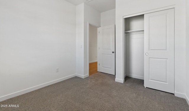 unfurnished bedroom featuring carpet floors and a closet