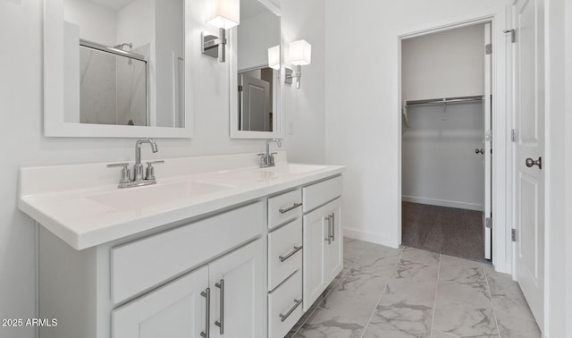 bathroom featuring an enclosed shower and vanity