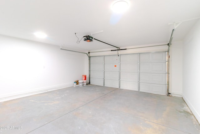 garage featuring a garage door opener and baseboards