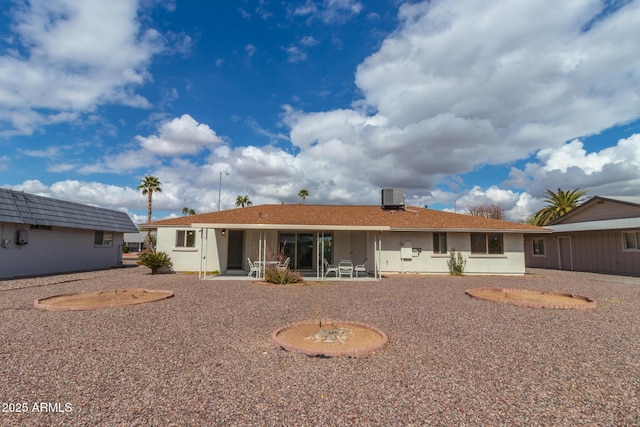 back of property featuring a patio and central AC