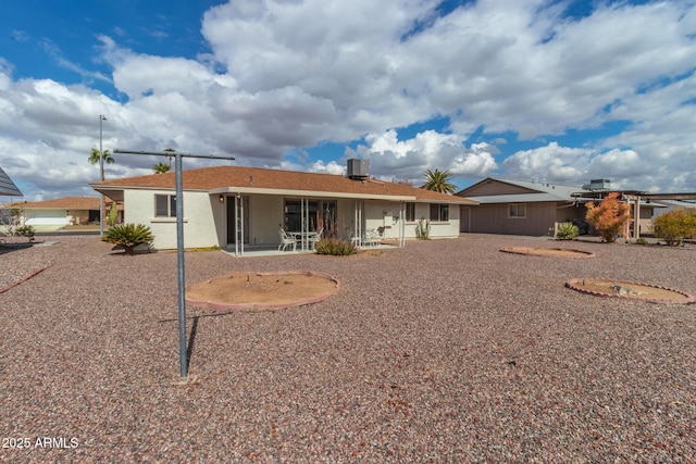 rear view of property featuring central AC and a patio area