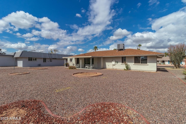 rear view of property featuring a patio and central AC unit