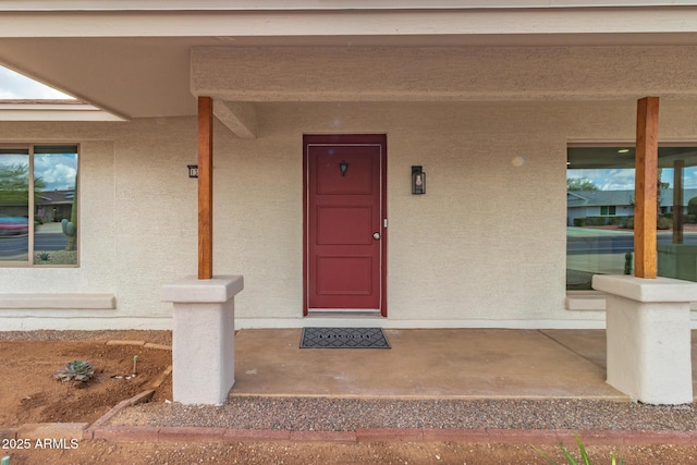 view of exterior entry with stucco siding