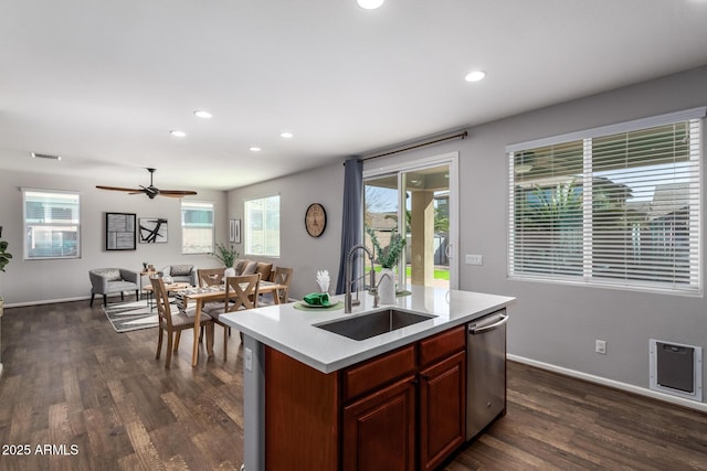 kitchen featuring sink, dark hardwood / wood-style floors, an island with sink, and dishwasher