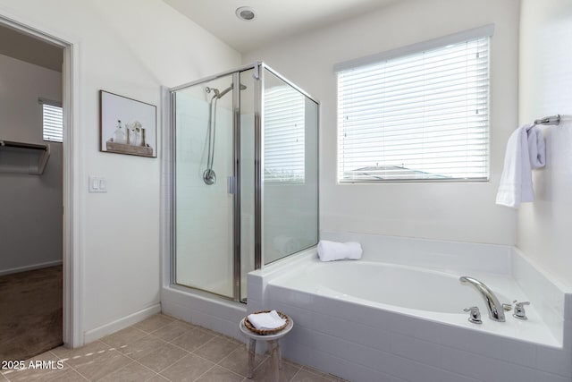 bathroom featuring tile patterned floors and separate shower and tub